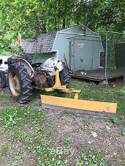 1952 8N Ford Tractor with backup plow attached