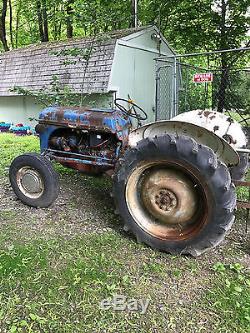 1952 8N Ford Tractor with backup plow attached