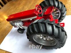 Farmall McCormick Deering 560 pulling tractor by Ertl toys in 1/16th scale