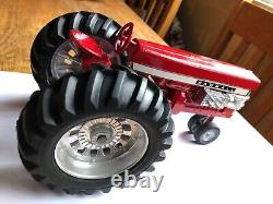 Farmall McCormick Deering 560 pulling tractor by Ertl toys in 1/16th scale